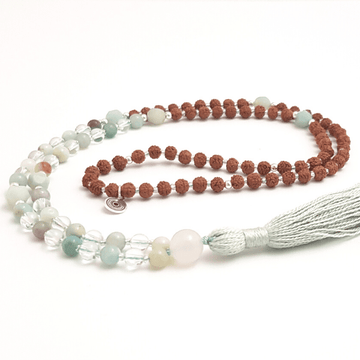 Handmade Affirmation Mala Necklace – Amazonite, Quartz & Rudraksha curled on white table
